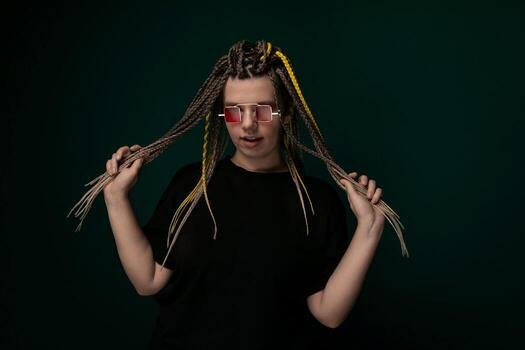 a-man-with-long-dreadlocks-and-red-glasses-photo